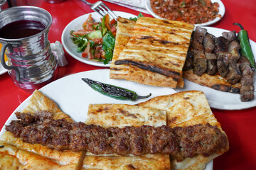 adana kebap with garni on the table
