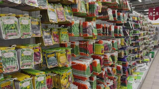 Flower and plant seeds: vegetables and fruits in the supermarket. Sale of plants, flowers, seeds, fertilizers, everything for the garden. A variety of seeds in bags