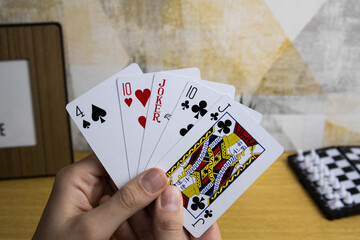 Two hands holds poker playing cards