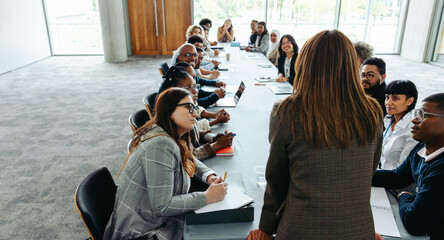 Leadership and business meeting with group of colleagues engaged in discussion
