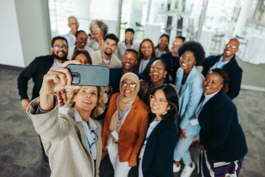 Diverse group of business professionals taking a selfie at a corporate event
