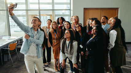 Team photo capturing unity and professional growth during an office gathering. Colleagues share a moment of togetherness and joy, emphasizing a collaborative and supportive work environment.