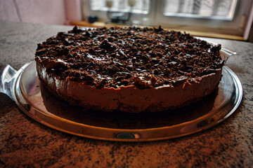 Chocolate cake on a plate in a kitchen