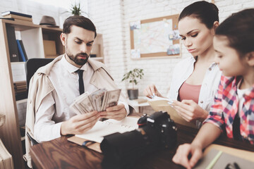 Private detective agency. Man is giving photos and woman is giving money.