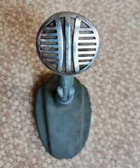 Vintage microphone isolated on the background closeup