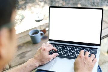 computer screen blank mockup.work using laptop with white background for advertising,contact business search information on desk at coffee shop.marketing and creative design
