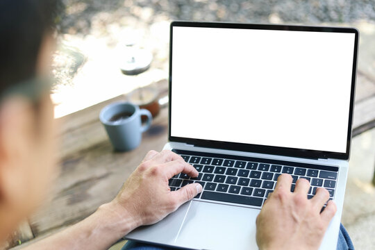 computer screen blank mockup.work using laptop with white background for advertising,contact business search information on desk at coffee shop.marketing and creative design