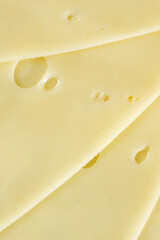 Semi-hard cheese close-up, thin slices, top view