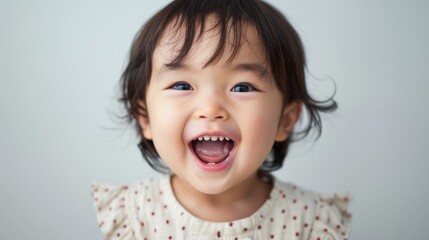 A baby girl smiling at camera, taken from her parents' perspective.