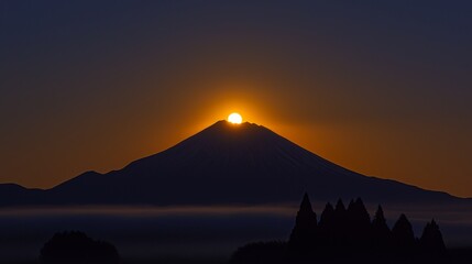 A dark mountain silhouette against a glowing moon
