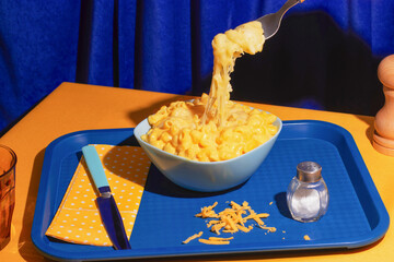 Creamy mac and cheese on vibrant table setting with fork