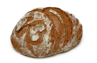 Artisanal bread with intricate patterns resting on a clean surface shines in warm light