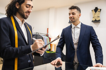 Tailor and Client in a Suit Store Collaborate on Style