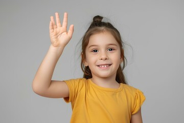 charming, happy, cheerful little girl portrait, looking to the camera, waving hello with a lovely and positive demeanor. Isolated on gray background 