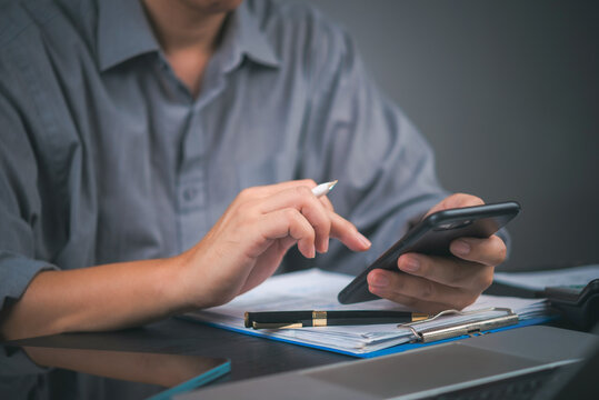 Man working, smartphone essential tool. Business, finance, data. Office, marketing.