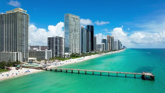 Sunny Isles Beach, Florida - Aerial of Newport Fishing Pier, with luxury condos lining the coastline.