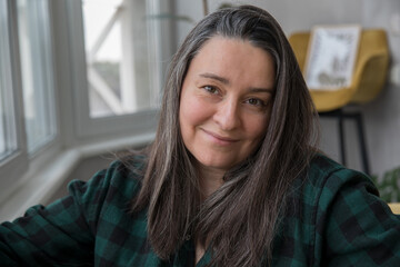 Portrait of a brunette 40+ years old with gray hair - obrazy, fototapety, plakaty