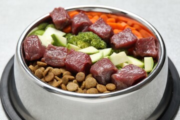 Dry pet food and natural products on light table, closeup