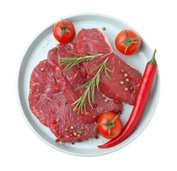 Pieces of raw beef meat, spices and tomatoes isolated on white