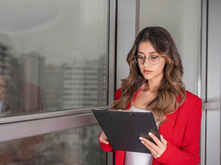 Busy business woman, portrait of beautiful serious busy business woman standing near big office...