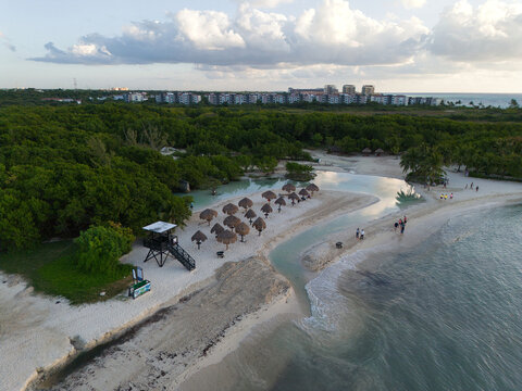 Beach with lifeguards tower,natural umbrellas and hotels in a background, drone photo - Powered by Adobe