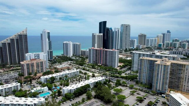 Sunny Isles Beach, Florida - Aerial of midrise condos and tall beachfront residential skyscrapers.