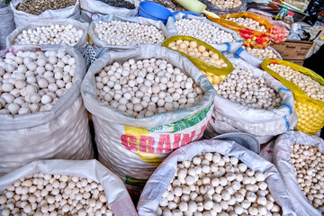 Bags with various types of traditional dried salted cheese, known as kurut in Kyrgyz, kurt in Kazakh, and kurtob in Uzbek, at a market in Central Asia.
