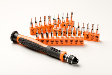 Set of magnetic precision screwdriver bits with black and orange handle on white background
