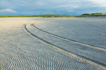Vehicle tracks in sand on beach, North Uist, Scotland