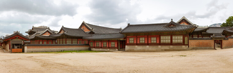 Fototapeta premium Traditional Korean Palace Complex Showcasing Historic Architecture With Ornate Roofs And Wooden Structures