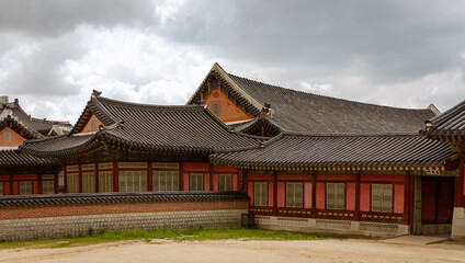 Traditional Korean Palace Showcasing Elegant Curved Roofs And Intricate Wooden Architecture In Historic Setting