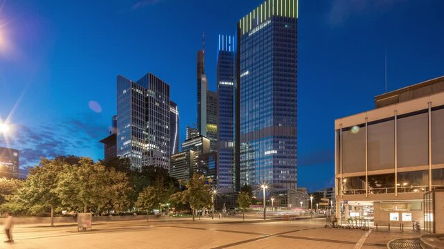 The Fairy-tale Fountain (Marchenbrunnen) before the Central European Bank in Frankfurt transitions from day to night timelapse hyperlapse, casting art-nouveau charm alongside illuminated skyscrapers
