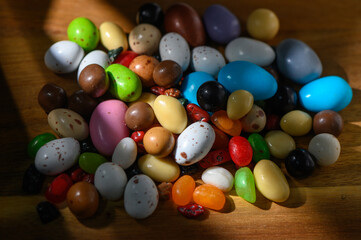 Colorful candy assortment scattered on a wooden surface during spring festivities