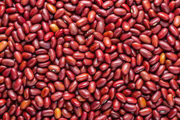 Texture of Red Kidney Beans: A close-up, macro shot reveals the rich, deep red hue and textured surface of a bountiful scattering of red kidney beans, perfect for culinary projects.
