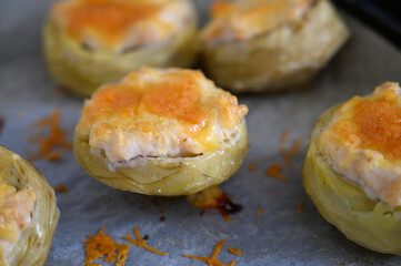 Savory artichoke hearts filled with creamy cheese and topped with golden brown crust during a sunny...