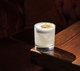 Refreshing cocktail served on wooden table in cozy setting