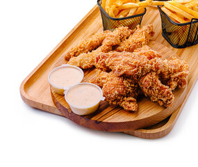 Fried chicken, fries, and dips on a wooden tray