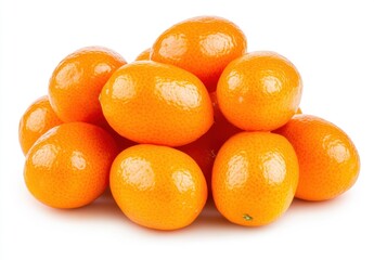 Pile of bright orange kumquats on a white background. The kumquats are glossy and appear juicy and ripe. Close up studio shot
