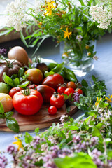 Tomato vegetable  -  a garden harvest of gourmet varieties of heirloom tomatoes, Solanum lycopersicum -  includes black, cherry, plum, oxheart and beefsteak delicious berries.
