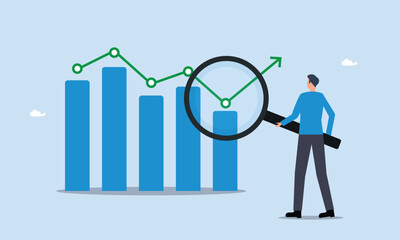Trend analysis, businessman analyst analyze trend graph and chart with magnifying glass. business forecast report concept, marketing and sales information, analyze or predict trend line or profit.