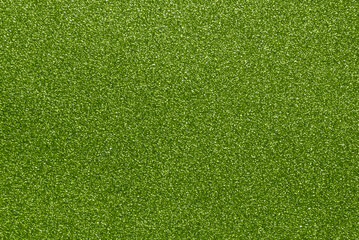 Green color sparkle glitter paper background close up