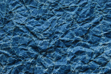 A sheet of old wrinkled glossy blue paper texture as background