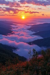 Fototapeta premium Sunrise illuminates a misty valley in the mountains during early morning hours
