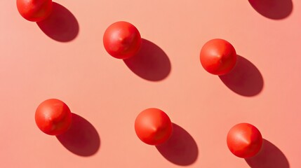 Playful red balls pattern on pink background casting shadows concept of april fool's day