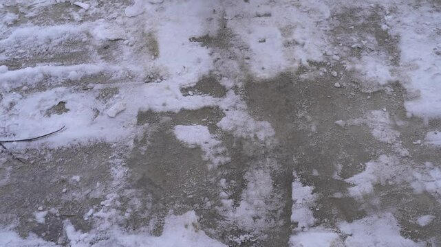 Removing snow with a shovel near the yard 
