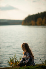 Fototapeta premium portrait of a five year old girl standing near a lake