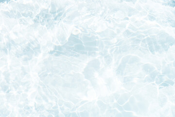 Blue water with ripples on the surface. Defocus blurred transparent blue colored clear calm water surface texture with splashes and bubbles. Water waves with shining pattern texture background.