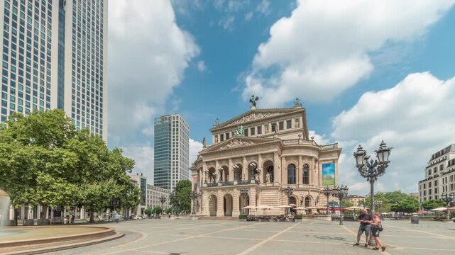 Hyperlapse of the Alte Oper (Old Opera) house in Frankfurt, a concert hall in Opernplatz. The square features a central fountain with people walking around, highlighting historic landmark timelapse
