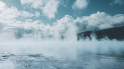 Serene landscape with misty lake, tranquil water reflecting clouds, ideal for relaxation or nature-themed projects.
