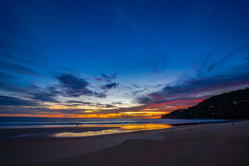 beautiful sky at twilight  above Karon beach Phuket with pink and orange hues illuminating the sky over Karon beach Phuket. The serene water create a peaceful and atmospheric view.